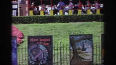 1967: trails of playground field trains moving along the track on a sunny day