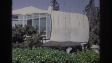 1967: people walking behind a bush under strange architecture OKLAHOMA