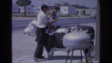 1967: a father places his small son on top of a fake bull