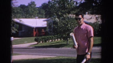 1967: man holding newspaper playing outdoor with glasses OKLAHOMA