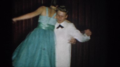 1965: couples wearing gown formal coat dancing