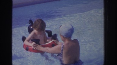 1972: a woman is teaching her baby to swim PHILADEPHIA PENNSYLVANIA