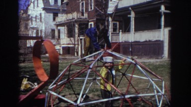 1973: children playing outside in a yard on a jungle gym/dome PHILADEPHIA