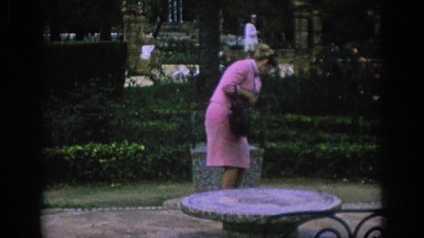 1966: Lady in Pink Sitting on Stone Block in Spain