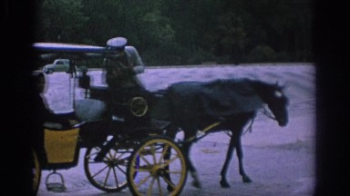 1966: Horse-Drawn Carriage Driver Stops to Converse with Two Passengers in Spain