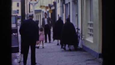 1961: people milling about on a side street in a city DUBLIN IRELAND