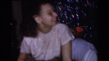 1968: Mom and Baby Opening Presents Under Christmas Tree in Omaha Nebraska