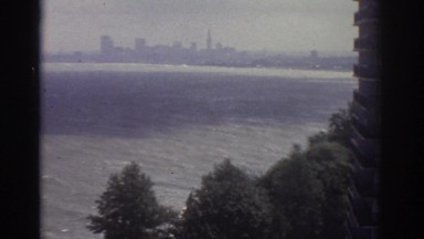 1974: View of a City Skyline and a Hotel with a Pool and a Tennis Court