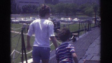 1974: two boys are playing near to a large crane with men CLEVELAND OHIO