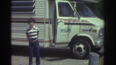 1974: two brothers coming out of a mobile home passenger door near the ocean