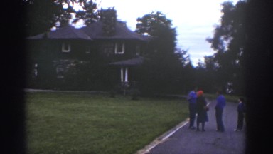 1976: people standing outside on the sidewalk. WATKINS GLEN NEW YORK