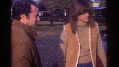 1976: couple and man in tan all discuss car issue WATKINS GLEN NEW YORK