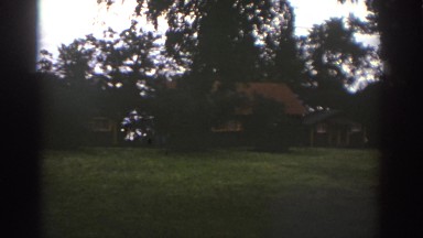 1976: slow scan of neighborhood green space and four people walking together