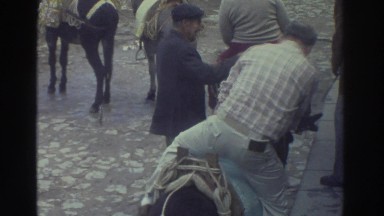 1976: Men Riding Donkeys Down a Paved Road Greece