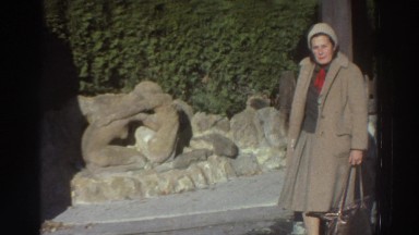 1976: Old Woman Standing Outside House Greece