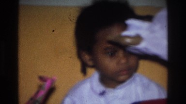 1975: a little girl is handed a folded sheet ATLANTA GEORGIA