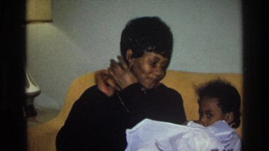 1975: mother teaching her daughter how to play with her baby doll. ATLANTA
