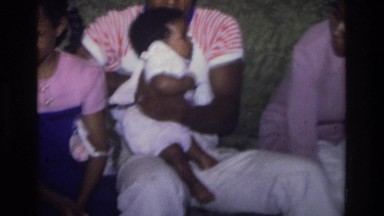 1975: a family sitting on the couch, the father holding a baby ATLANTA GEORGIA