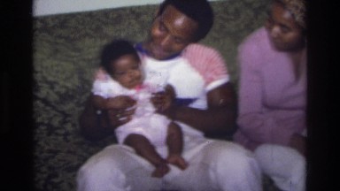 1975: man holding a baby ATLANTA GEORGIA