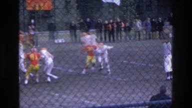 1975: watching a football game in action. BRONX NEW YORK