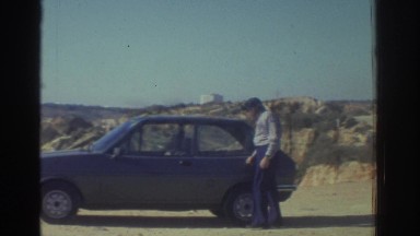 1976: Man Approaches Vehicle, Opens Driver's Side Door, and Leans Inside