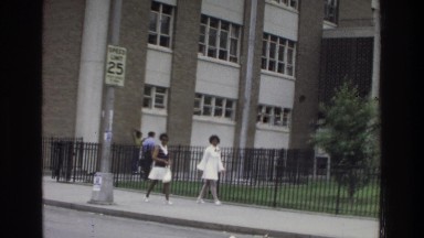 1975: 2 ladies walking outside of building BRONX NEW YORK