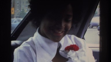 1975: a woman sitting in the backseat, talking and laughing. BRONX NEW YORK