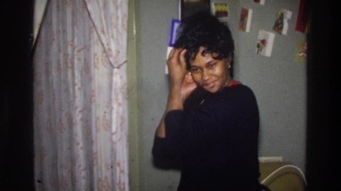 1975: an african american woman adjusting the wig on her head WASHINGTON DC