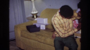 1976: african-american children play with presents in a living room HARLEM