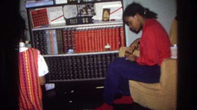 1975: three cute children in the house engaged in different activities