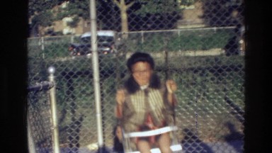 1976: some kids having fun on a swingset at the park HARLEM NEW YORK