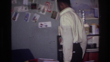 1976: Young Boy Looking at Christmas Tree and Getting Ready to Open Gifts.