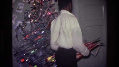 1976: boy hanging stockings HARLEM NEW YORK