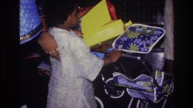 1976: a beautiful kid moving with trolley in the shop HARLEM NEW YORK