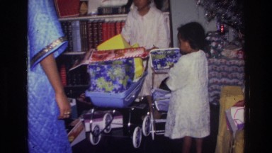 1976: two little girls receiving presents from parents HARLEM NEW YORK