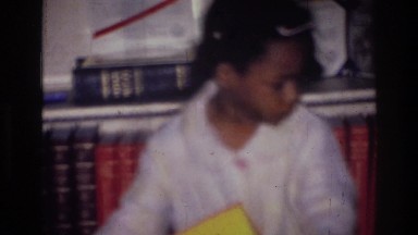 1976: cute child in a school area with books around HARLEM NEW YORK