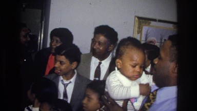 1976: a group of people standing in the room with a happy mood HARLEM NEW YORK