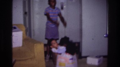 1976: children playing with one another inside their apartment. HARLEM NEW YORK