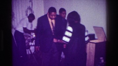 1976: man and woman dancing during a party, enjoying music and beverages HARLEM