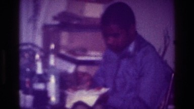 1976: middle aged african-american man taking a break from work to enjoy a home