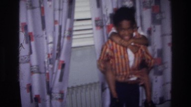 1976: brother and sister goofing off in the living room. HARLEM NEW YORK