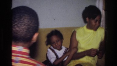 1976: mother getting her kids ready to leave. HARLEM NEW YORK