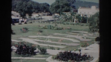 1962: Panoramic View of a Castle with Gardens, Picnic Area, Trees, and Pool in Rhodes, Greece