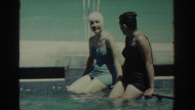 1962: Two Women Relaxing in Pool, Sitting on Bar, Rhodes Greece