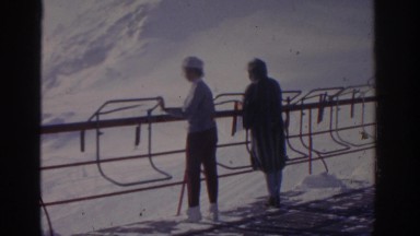 1963: Two People at Ski Resort Watching Snowy Mountains Munich Germany