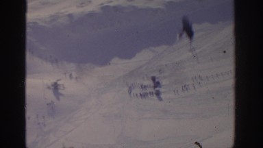 1963: a snow-laden mountain with cable cars carrying tourists between mountain
