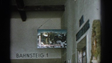 1963: handheld camera zooming in on german signage depicting nature hanging out