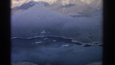 1963: aerial view of a crater lake in the mountains. MUNICH GERMANY