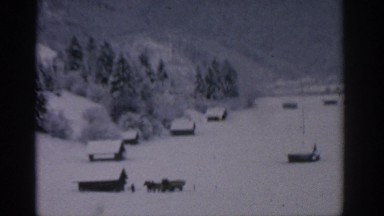 1963: snow covered area with houses and a mountain view MUNICH GERMANY
