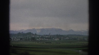 1963: Footage of Colorado Mountains Against Water Zurich Switzerland